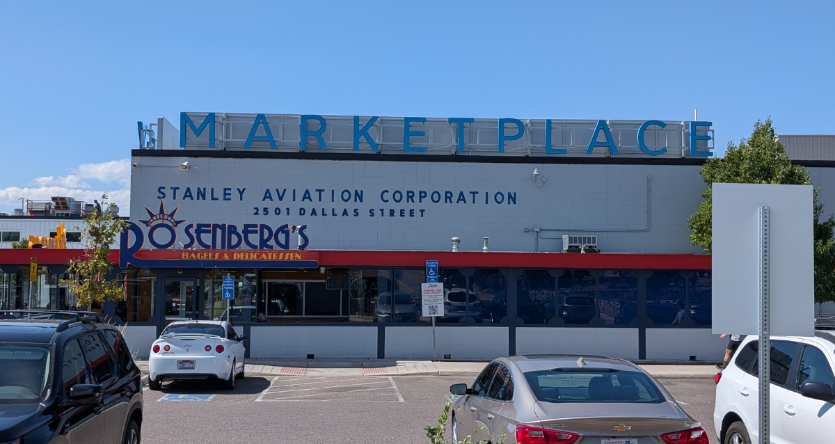 A building with cars parked in front of it.