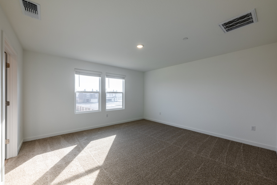 A room with a window and a carpet.