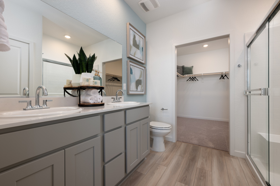 A bathroom with a sink toilet and a shower.