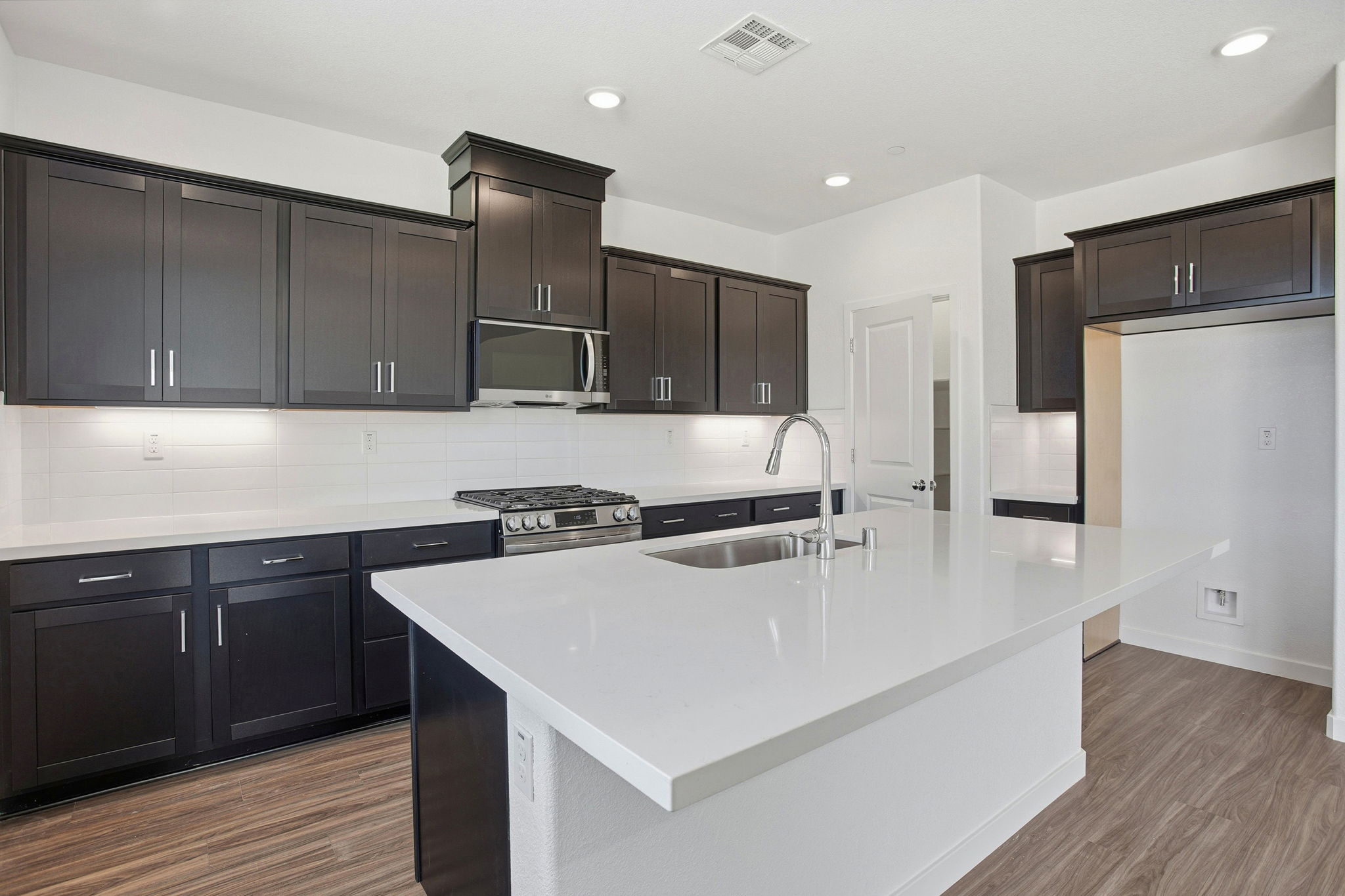 A kitchen with black cabinets.