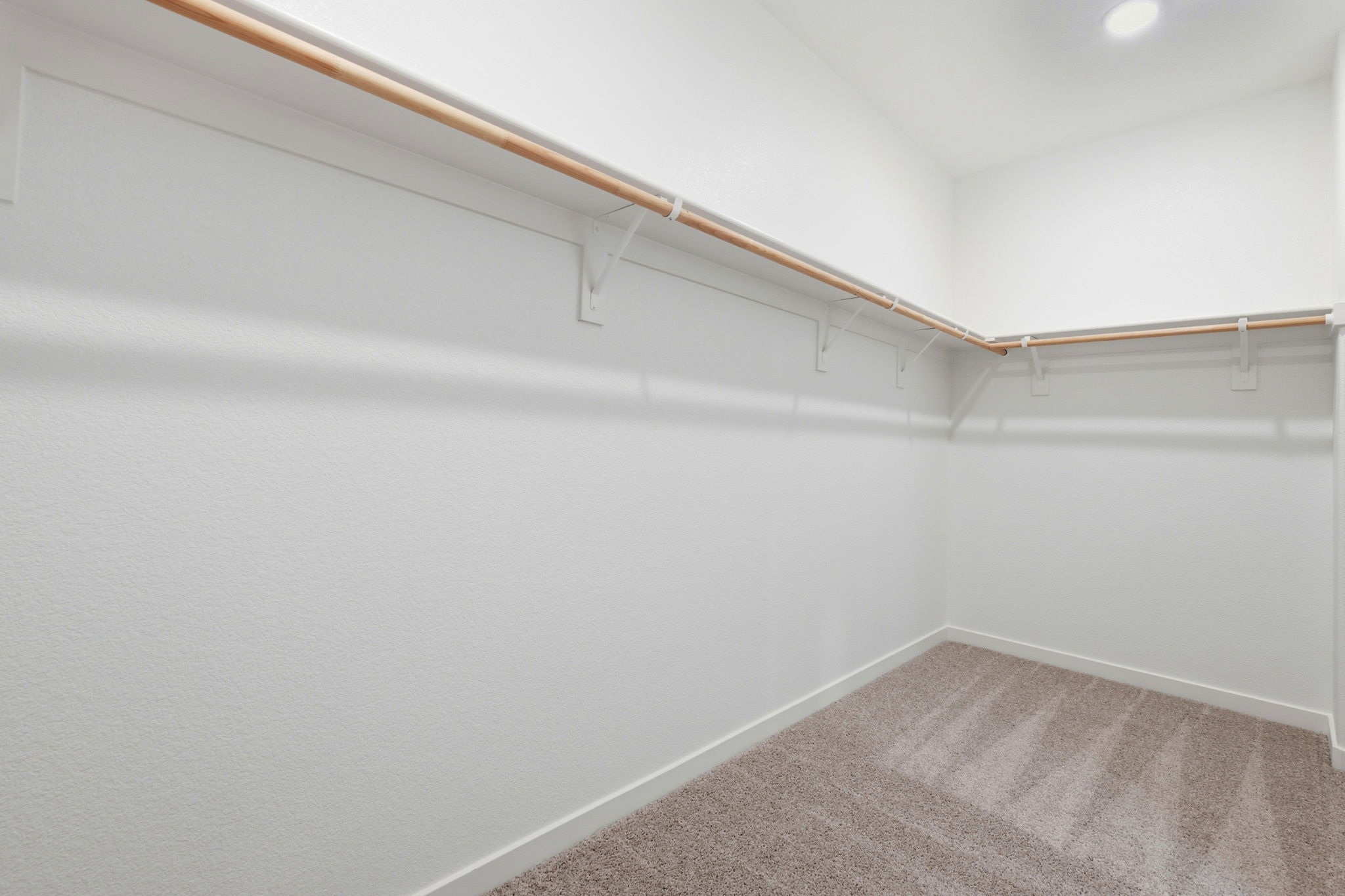 A white wall with a wood railing.