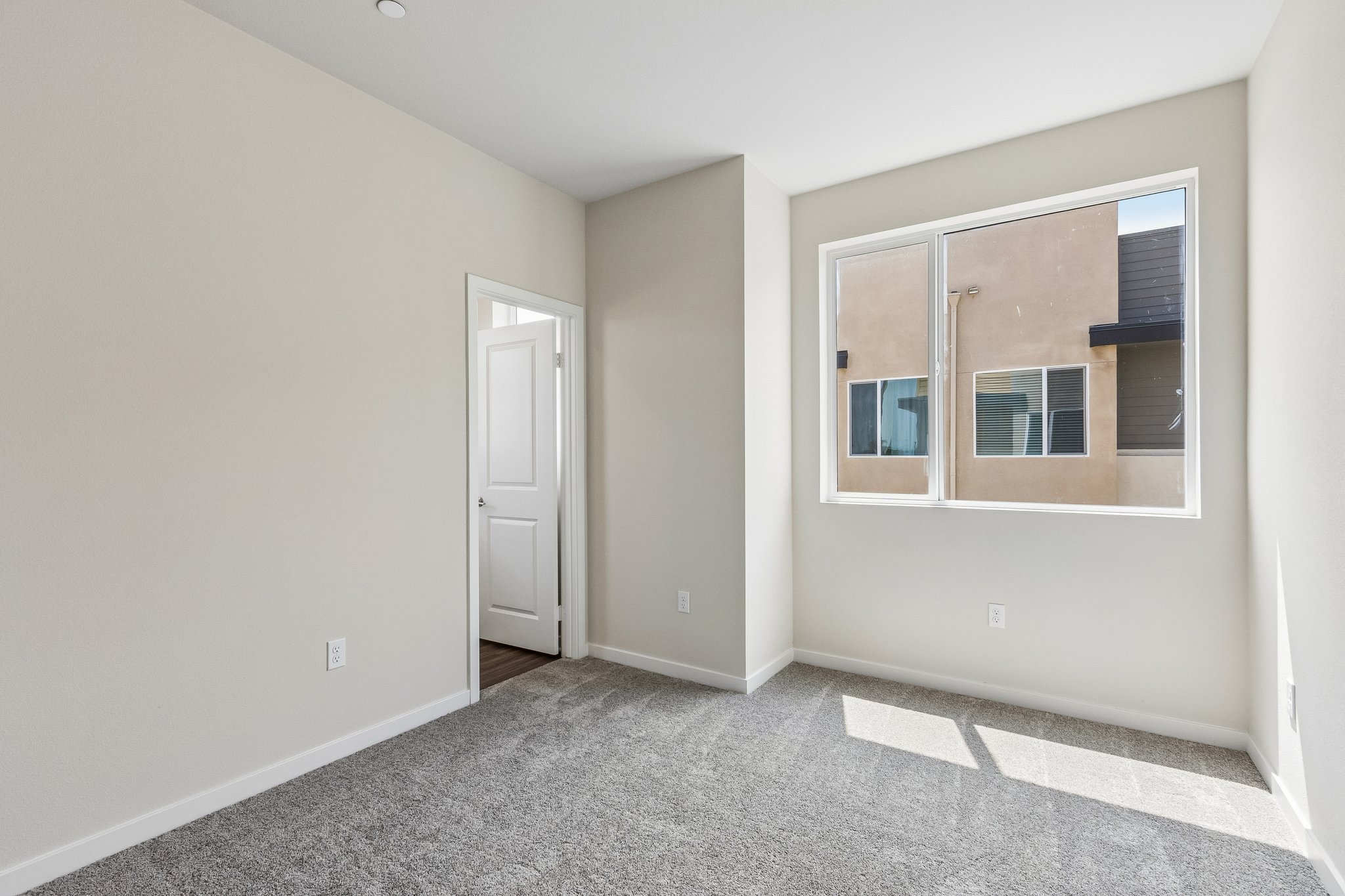 A room with a window and a door.