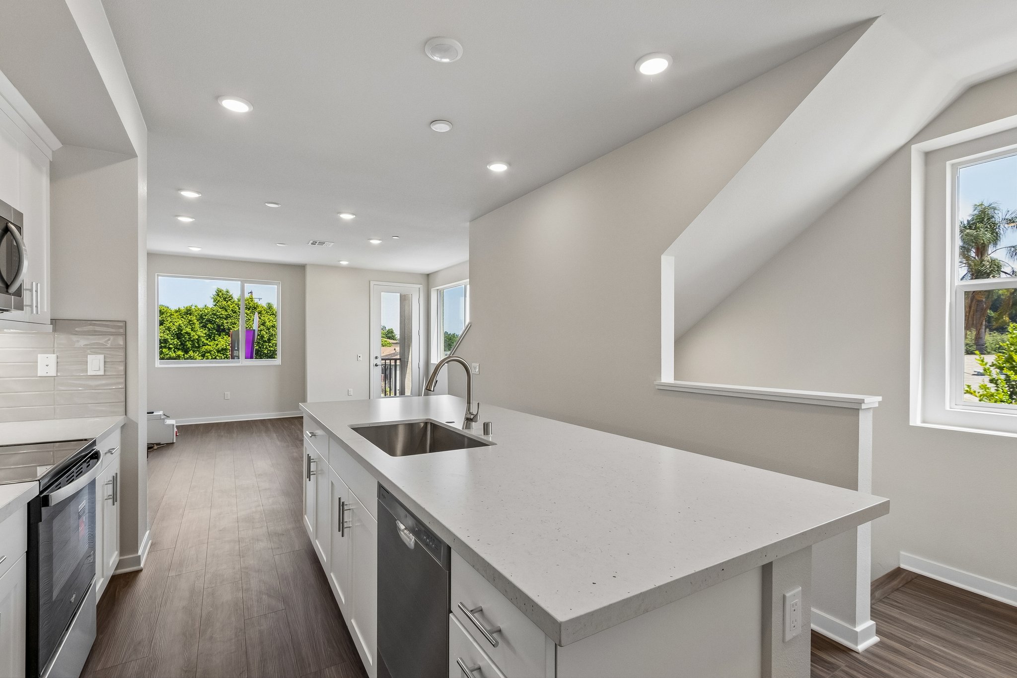 A kitchen with white cabinets.