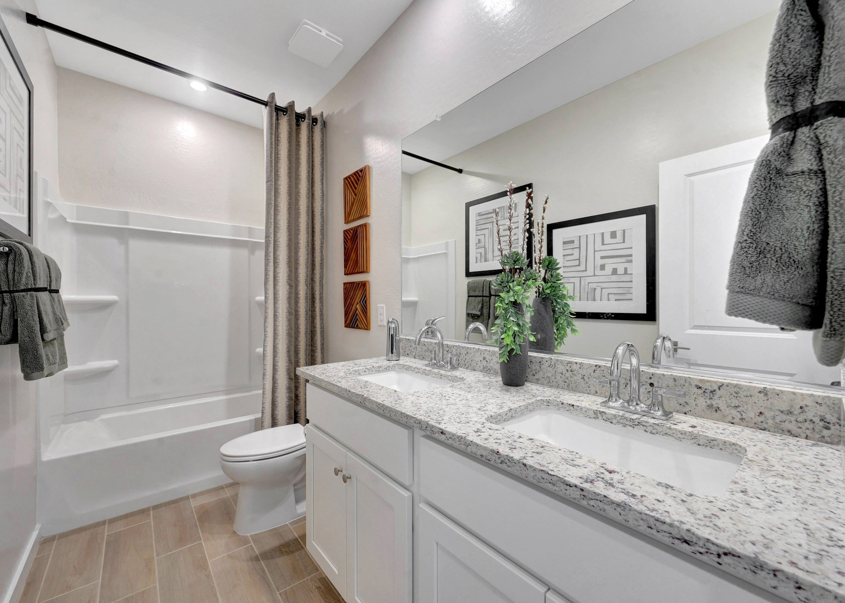 A bathroom with a tub sink and toilet.