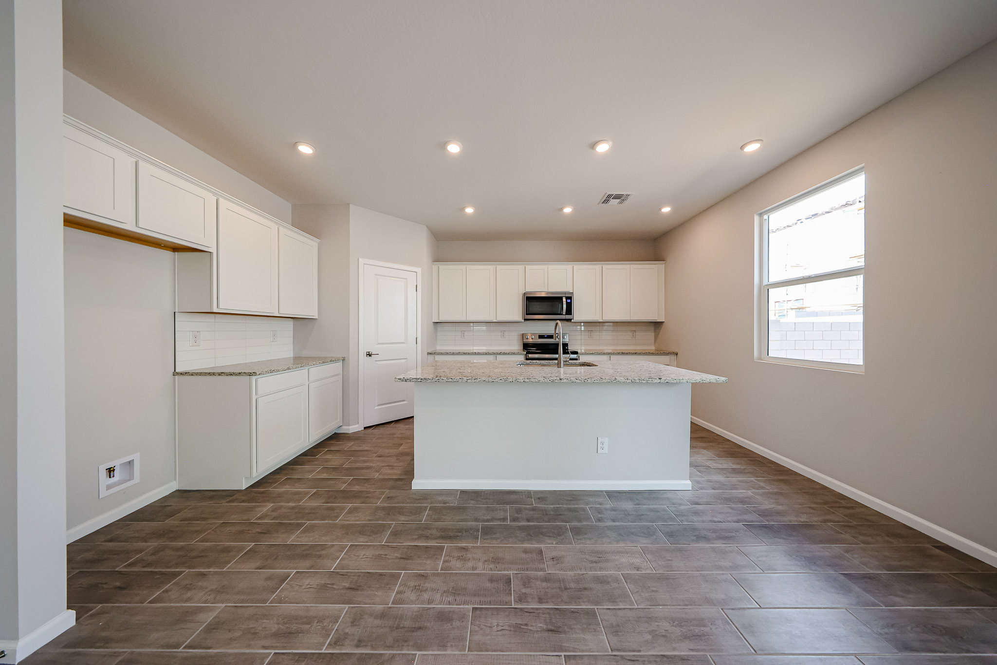A kitchen with white cabinets.