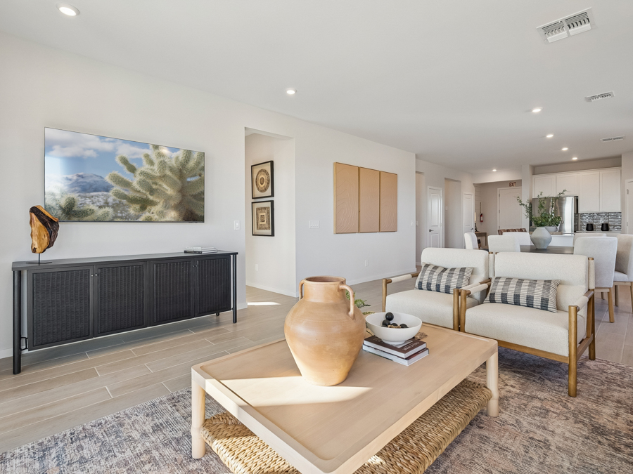 A living room with a large painting.