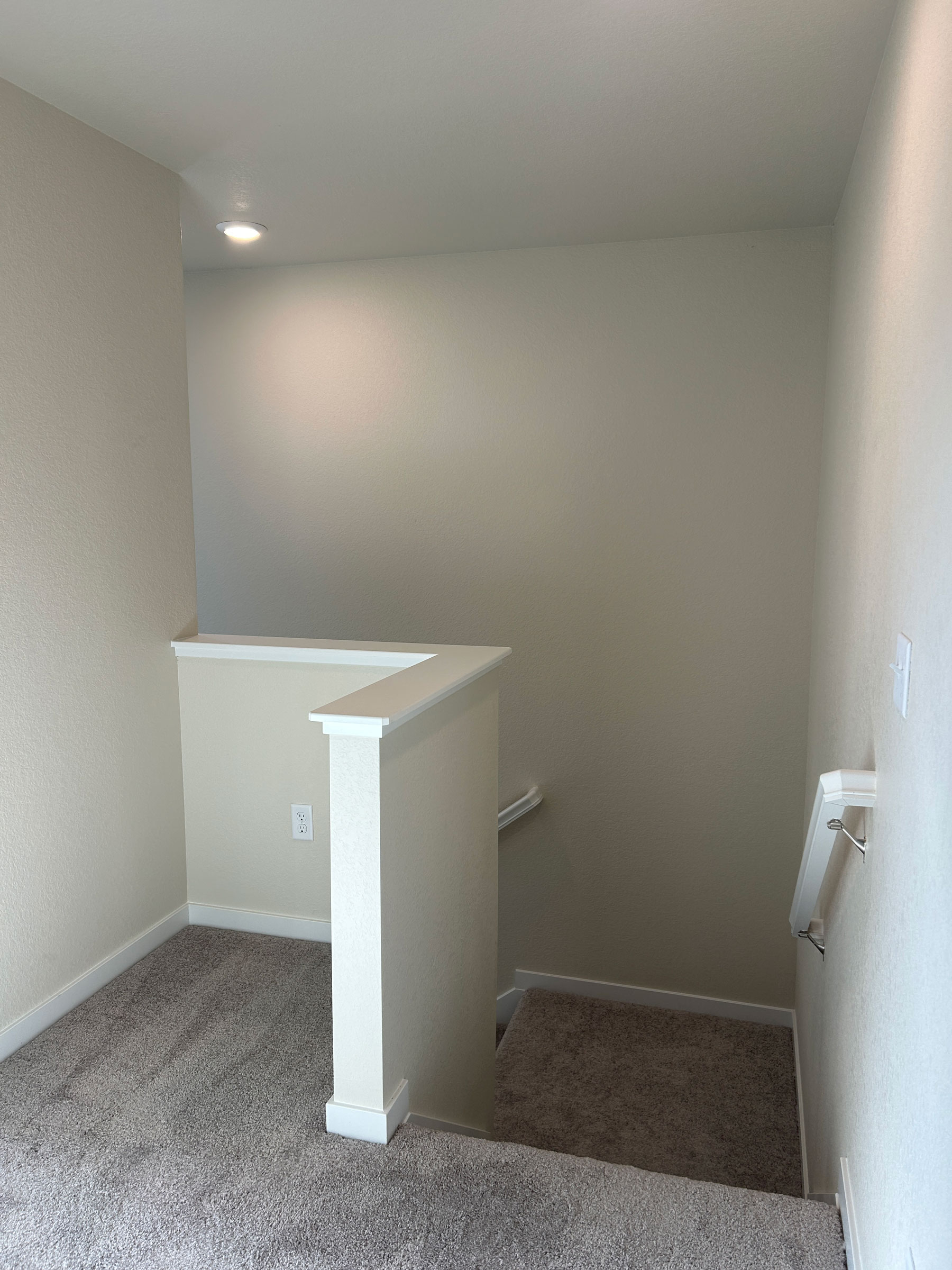 A room with a white cabinet and a rug.