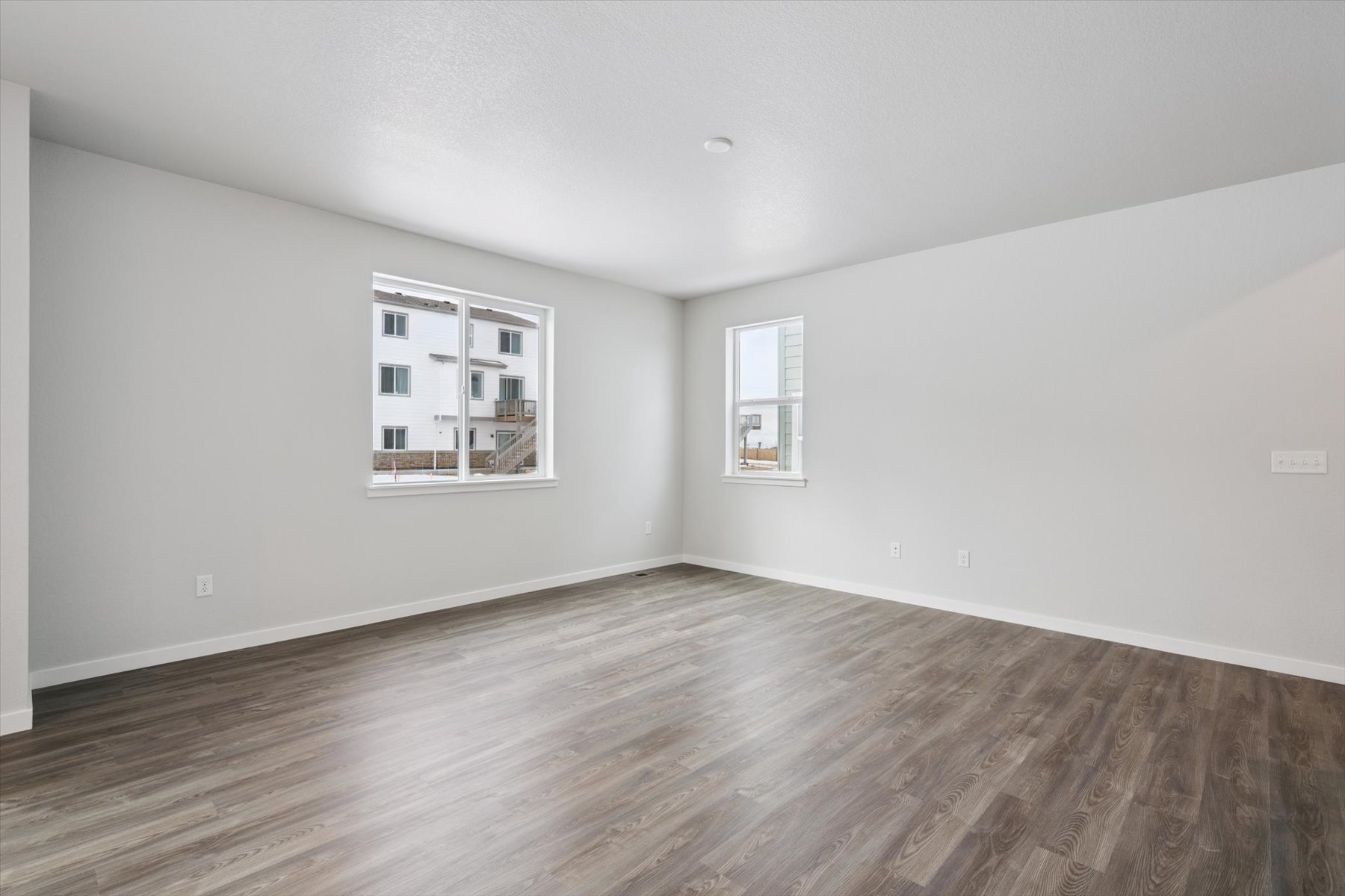 A room with a wood floor and a window.