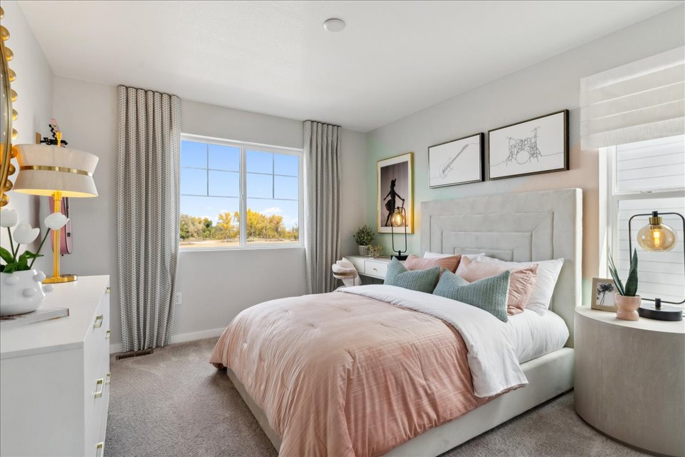 A bedroom with a bed and lamps.