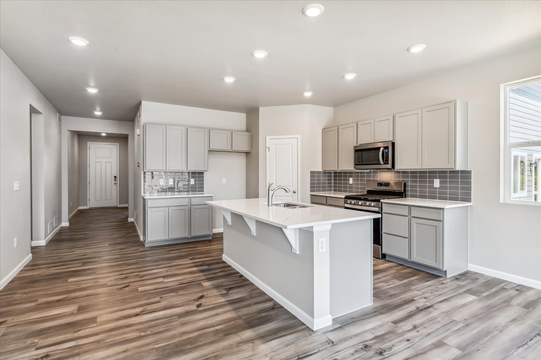 A kitchen with white cabinets.