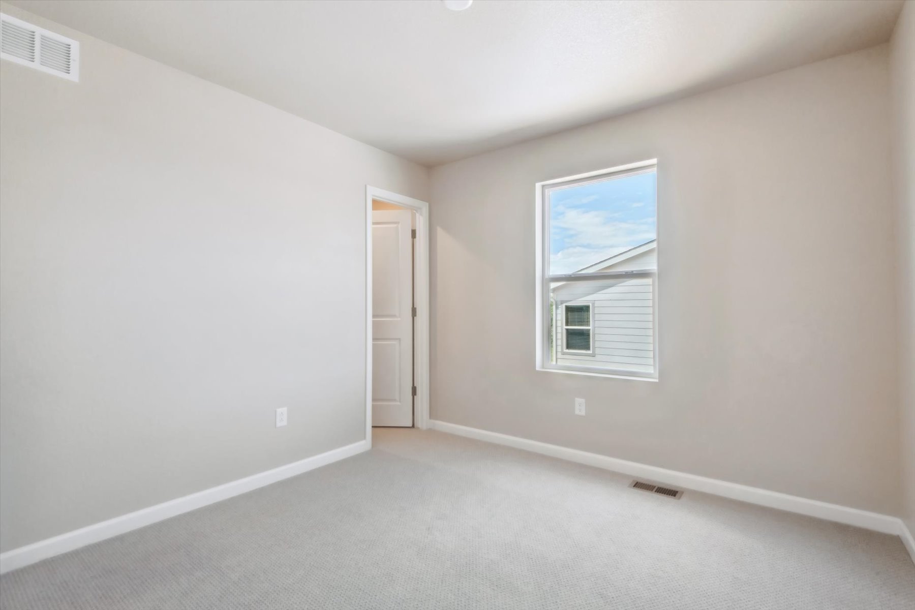 A room with a window and a door.