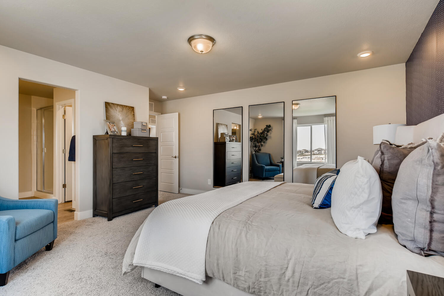 A bedroom with a bed and a couch.