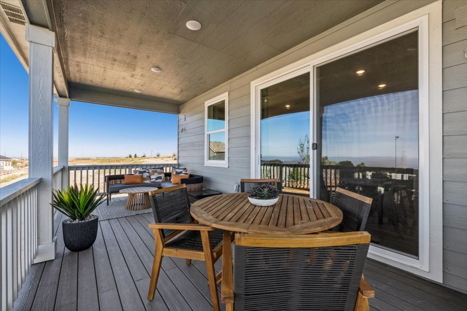 A table and chairs on a deck.