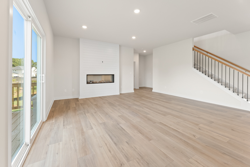 A room with a wood floor and white walls.