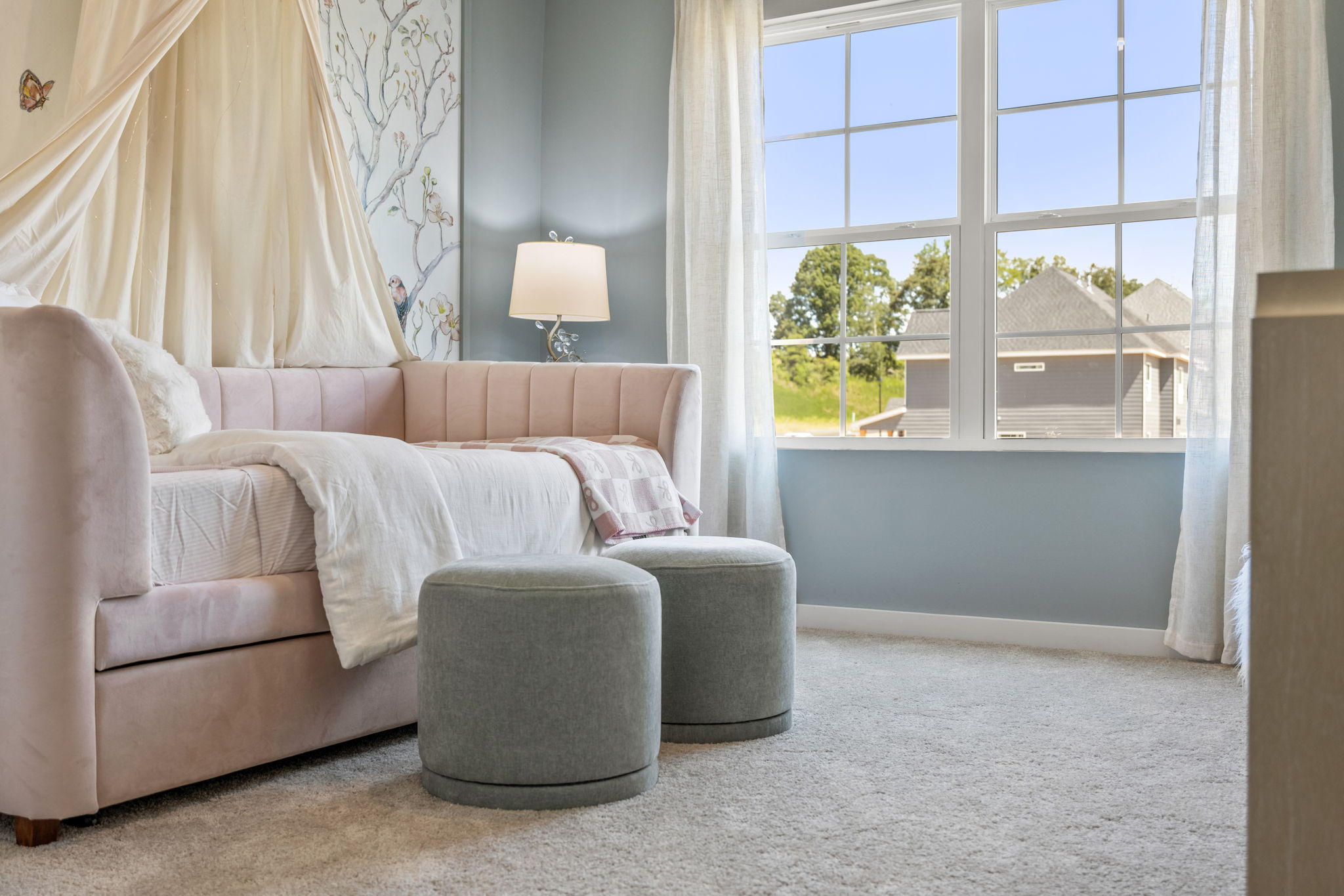 A room with a couch and a lamp.