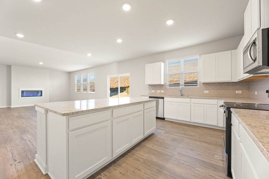 A kitchen with white cabinets.