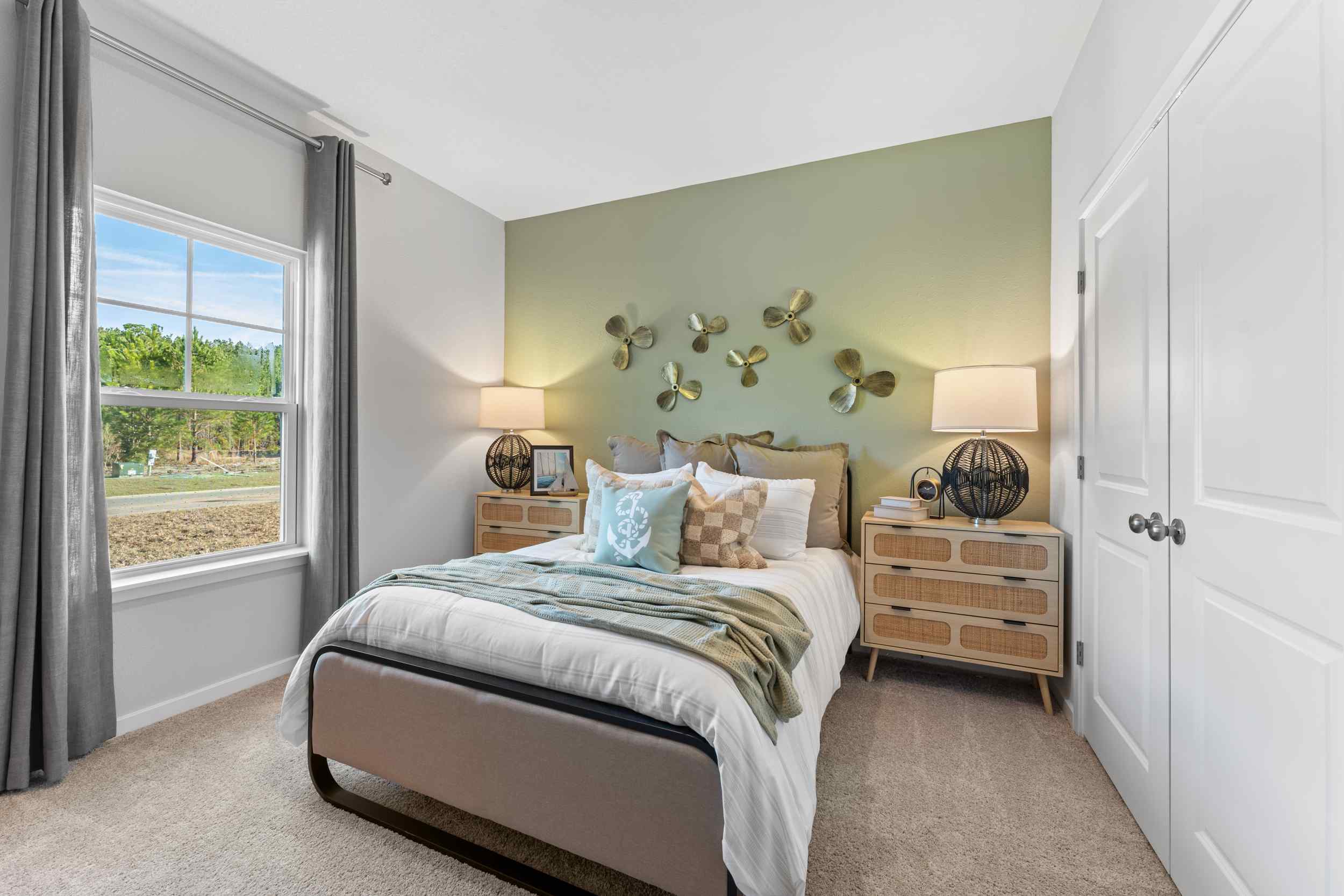 A bedroom with a bed and a window.