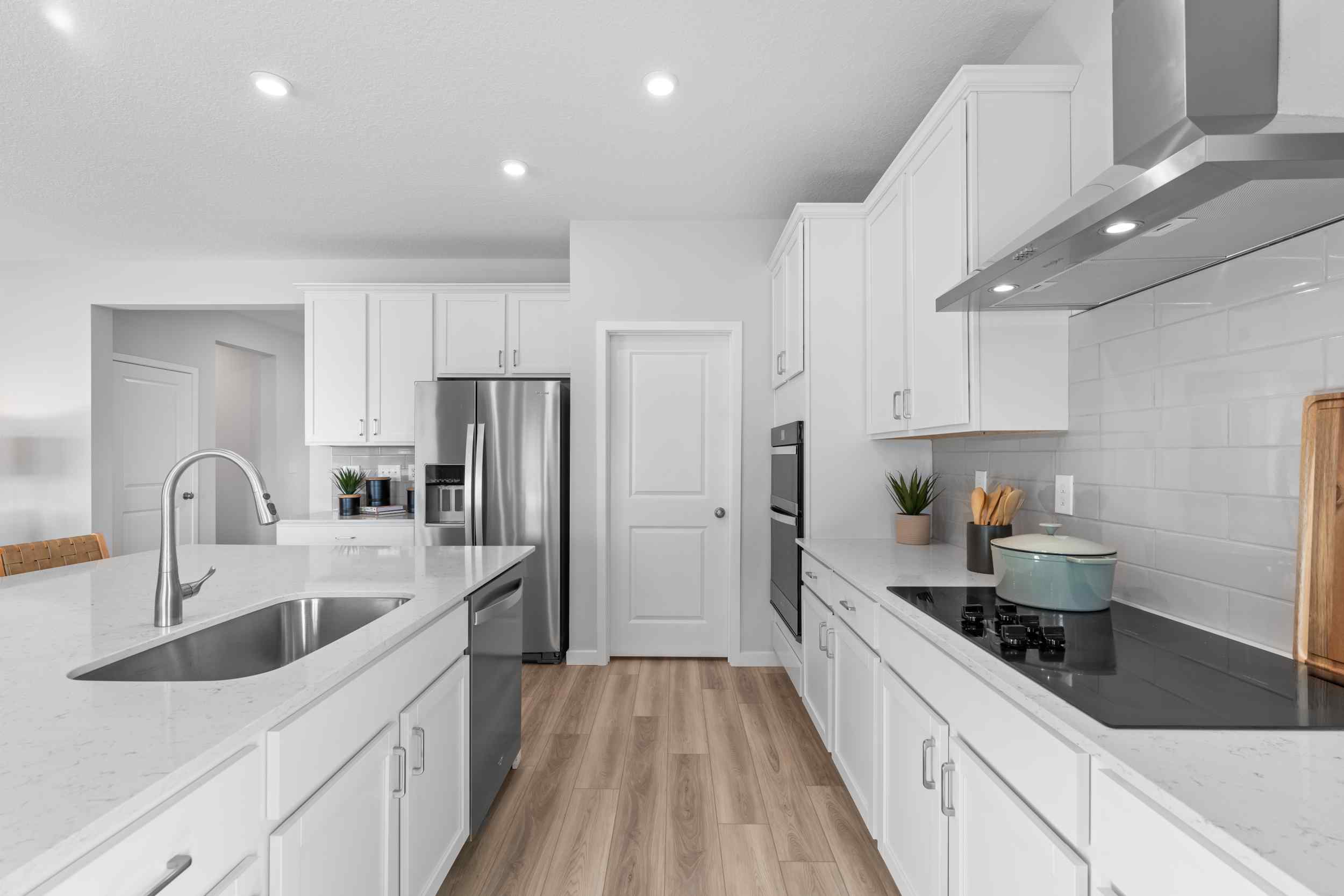 A kitchen with white cabinets.
