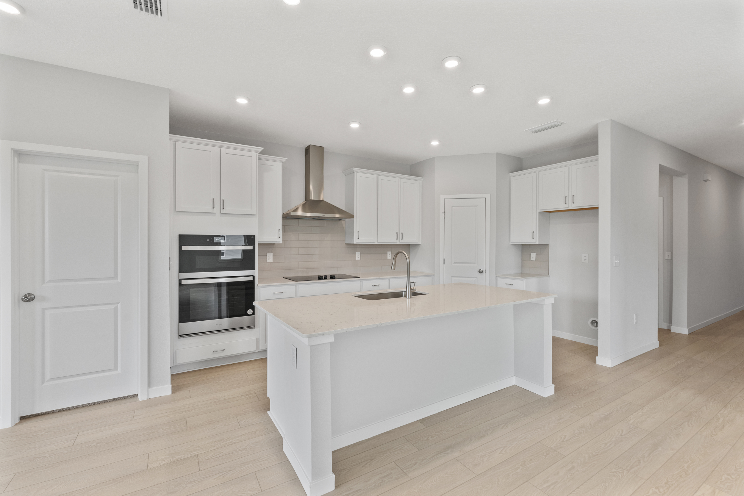 Palmetto Floorplan Lot 49 Chef's Kitchen with White Cabinets at Seminole Palms in Palm Coast