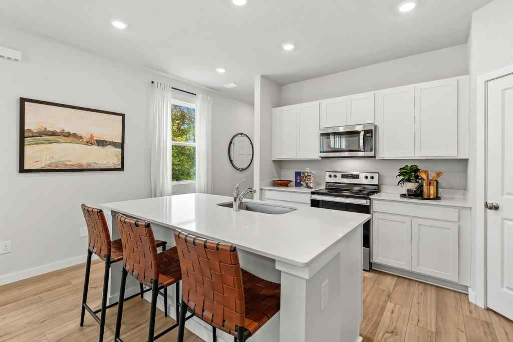 A kitchen with white cabinets.