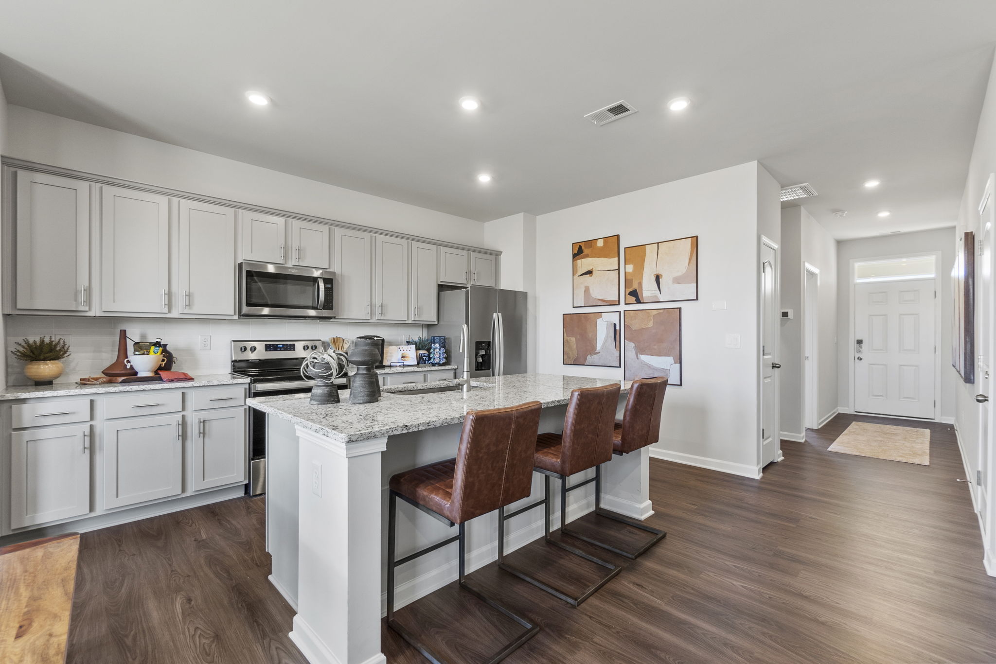 A kitchen with white cabinets.