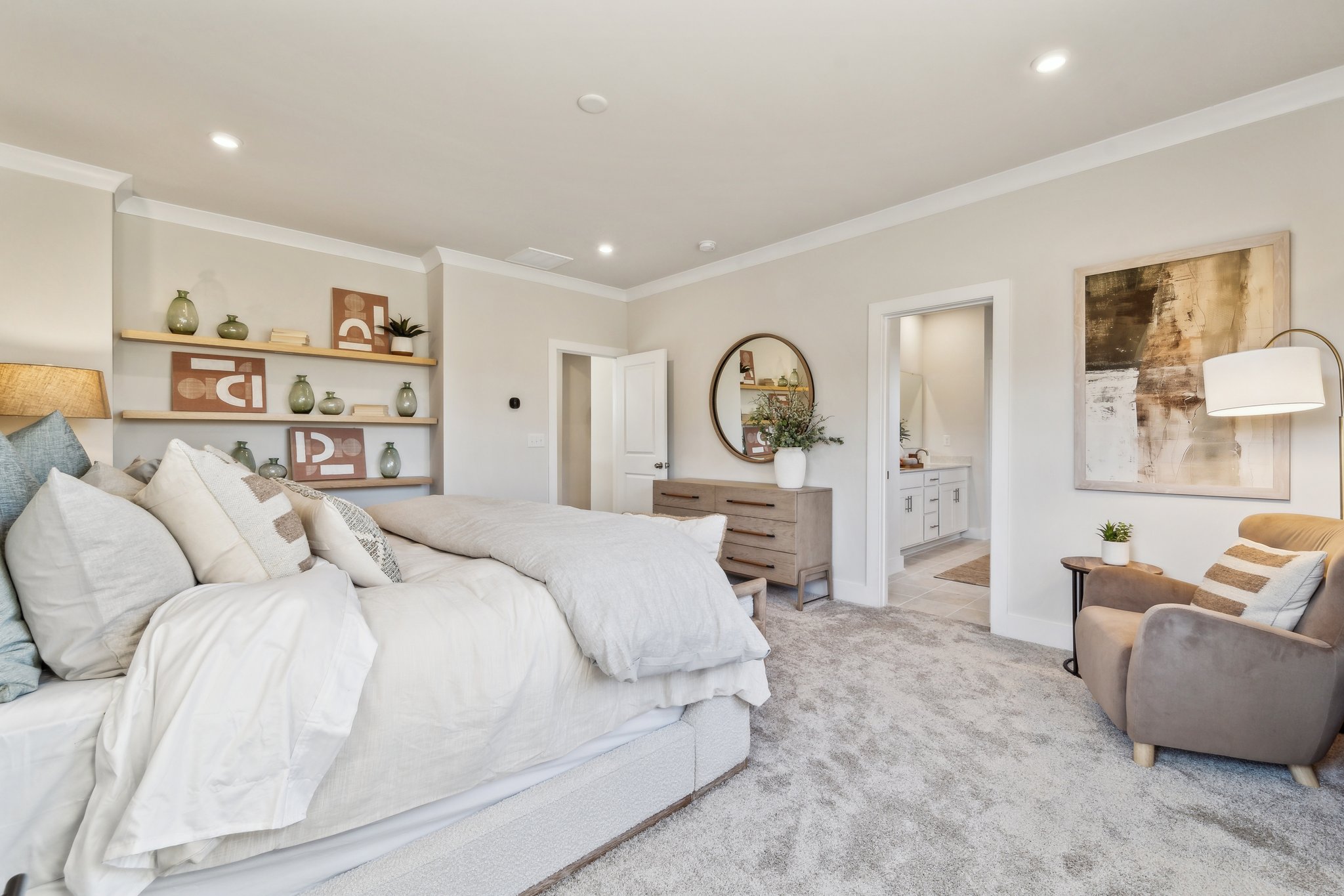 A bedroom with a bed and a chair.