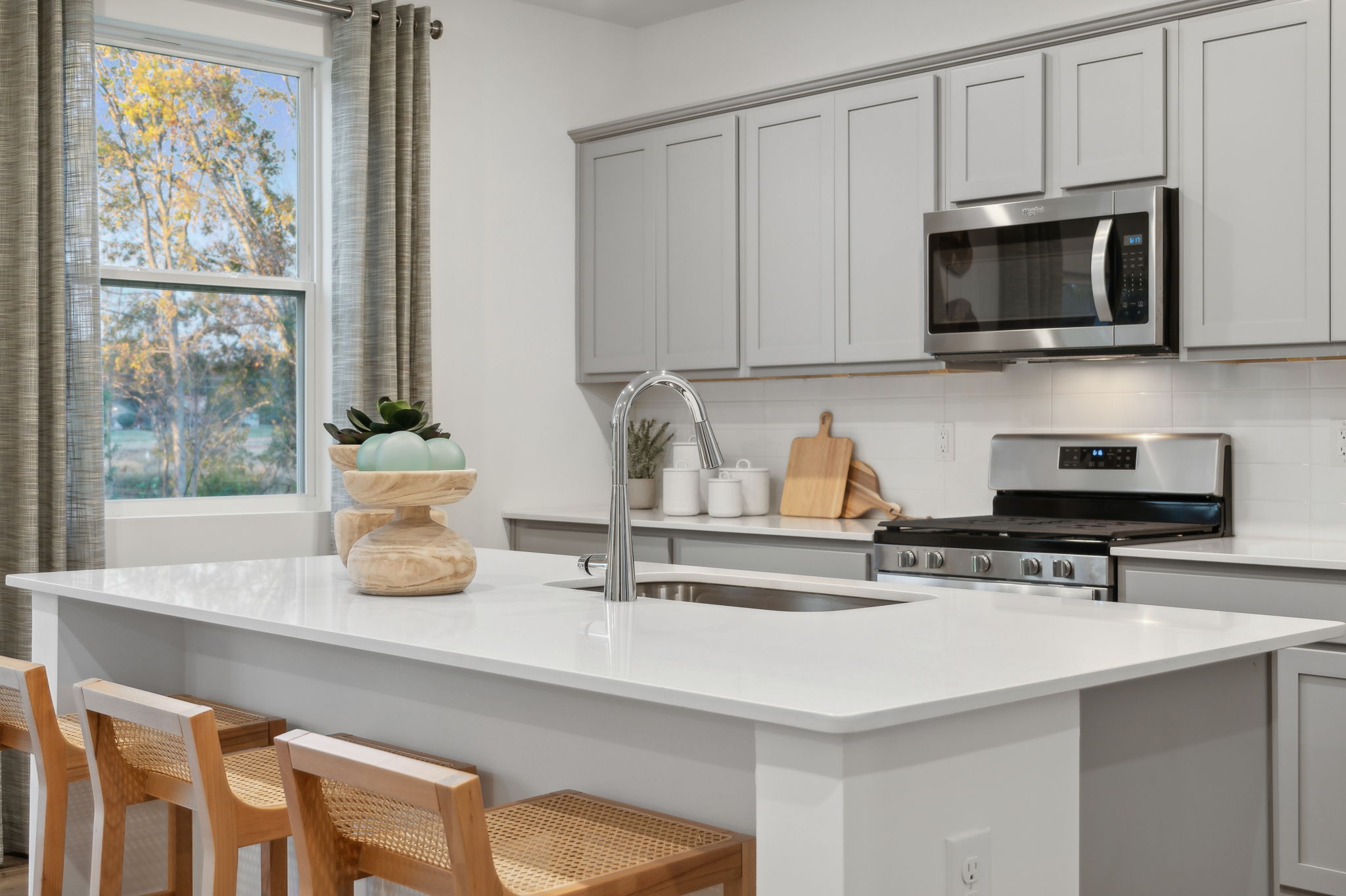 A kitchen with white cabinets.