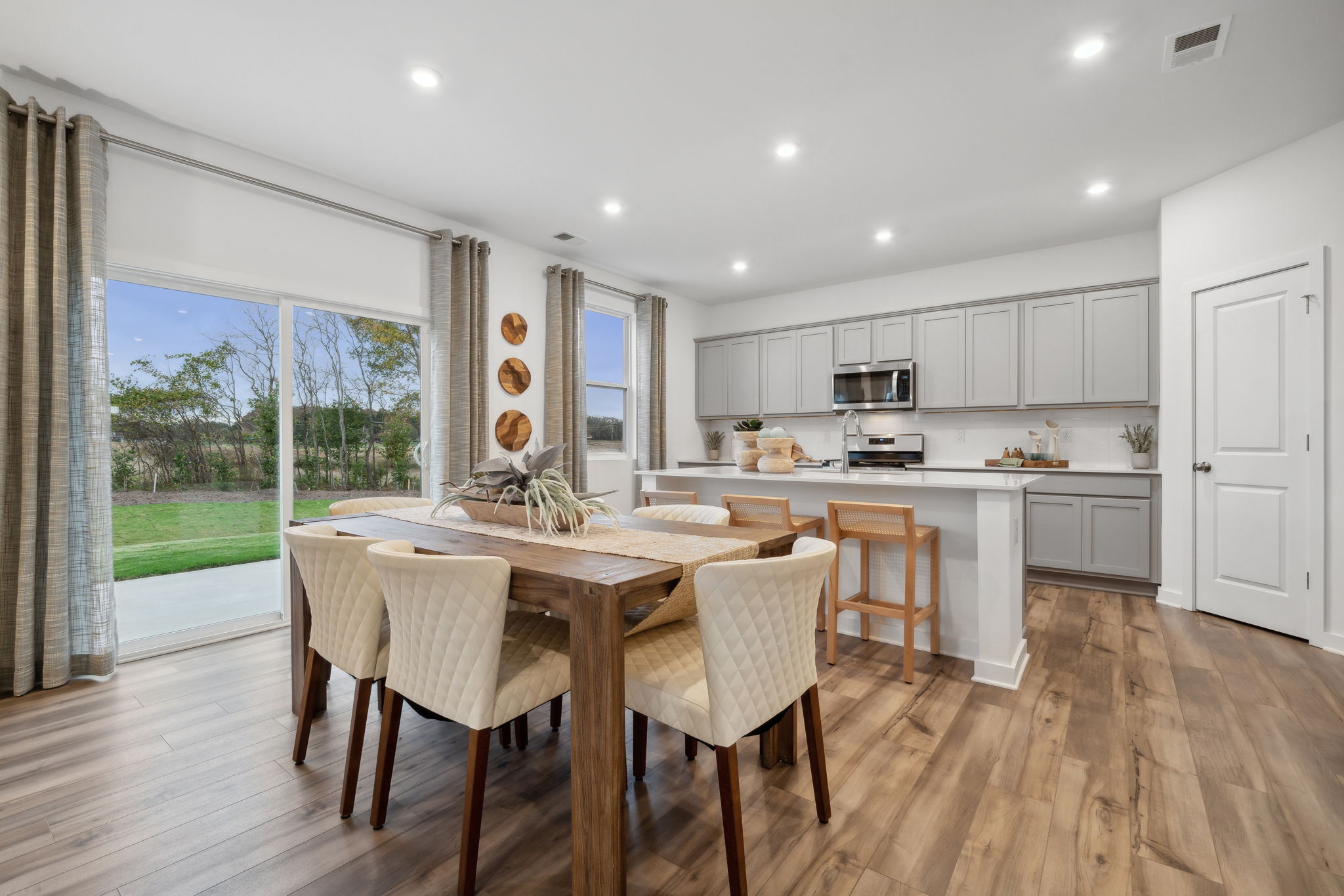 A kitchen with a dining table and chairs.