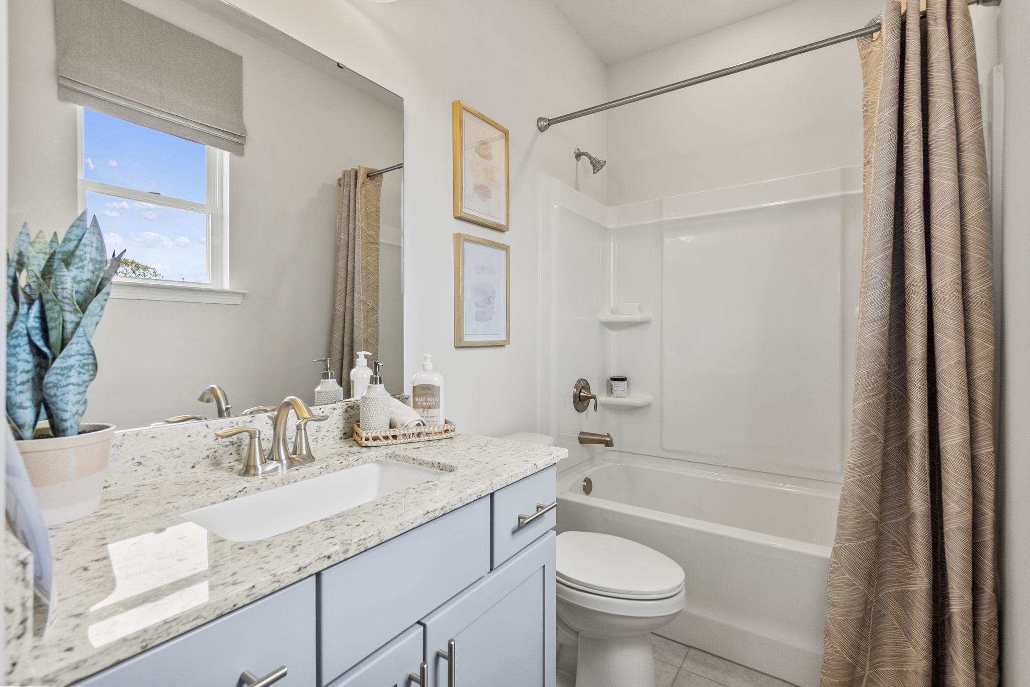A bathroom with a shower and sink.