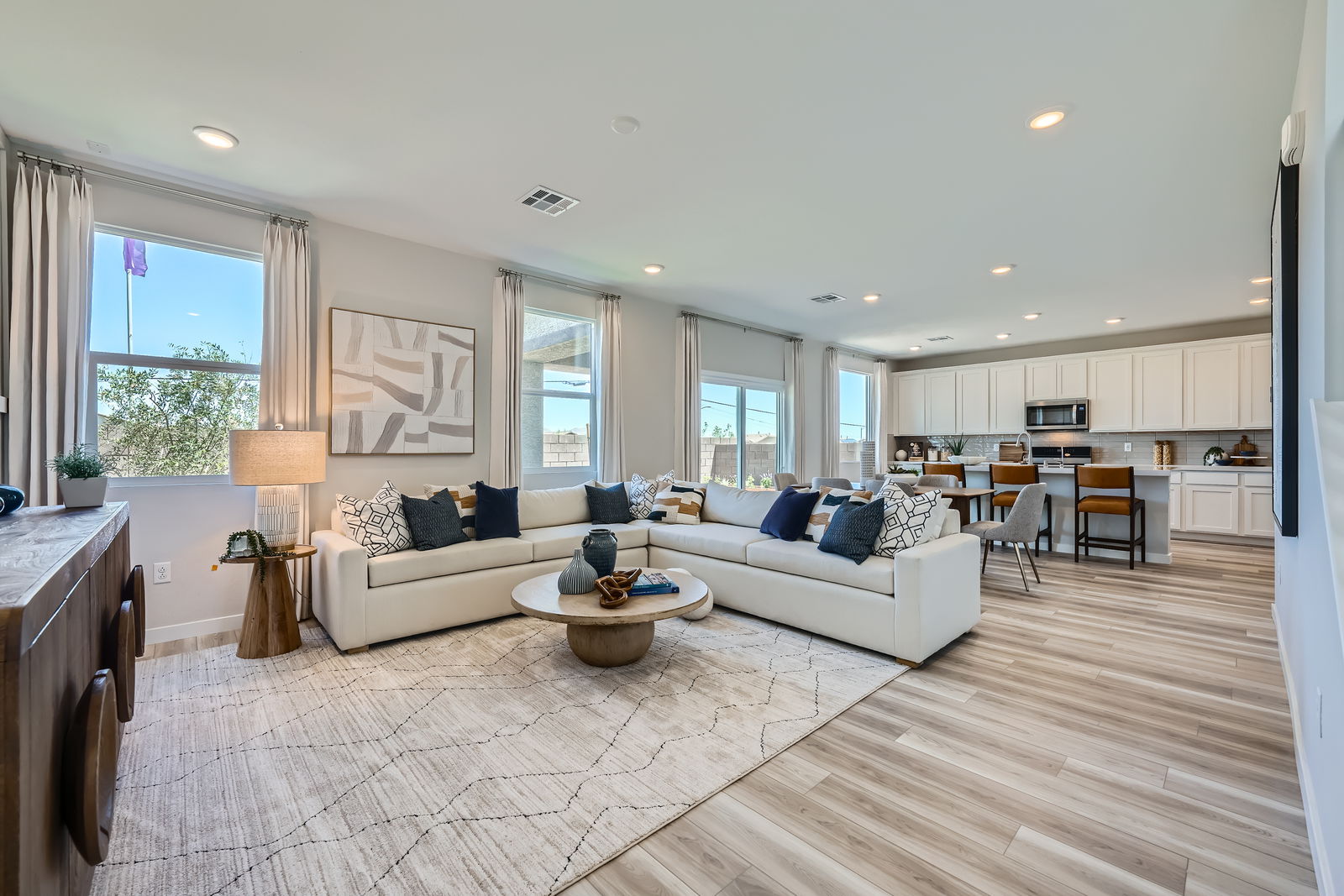 A large living room with a wood floor.
