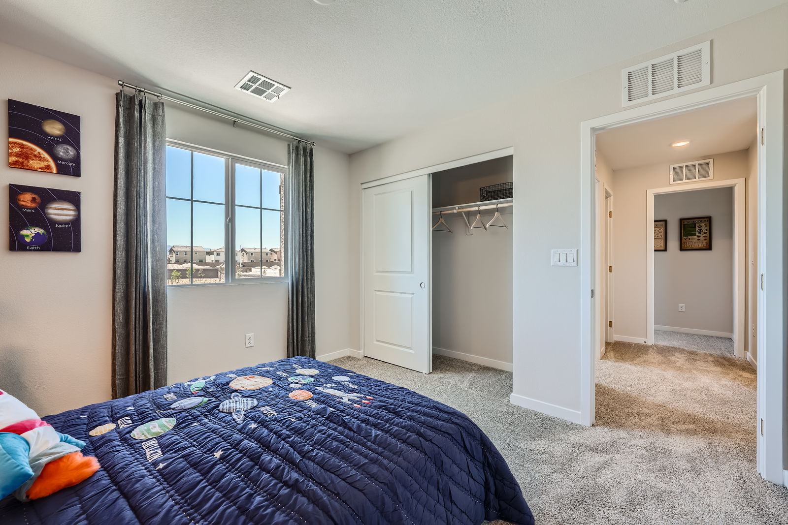 A bedroom with a bed and a window.