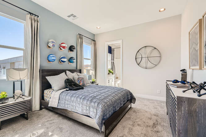 A bedroom with a bed and a desk.