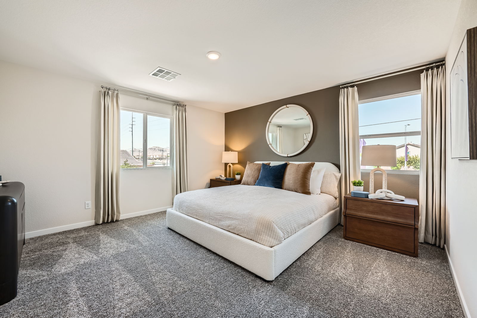 A bedroom with a large mirror.