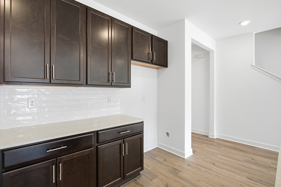 A kitchen with black cabinets.