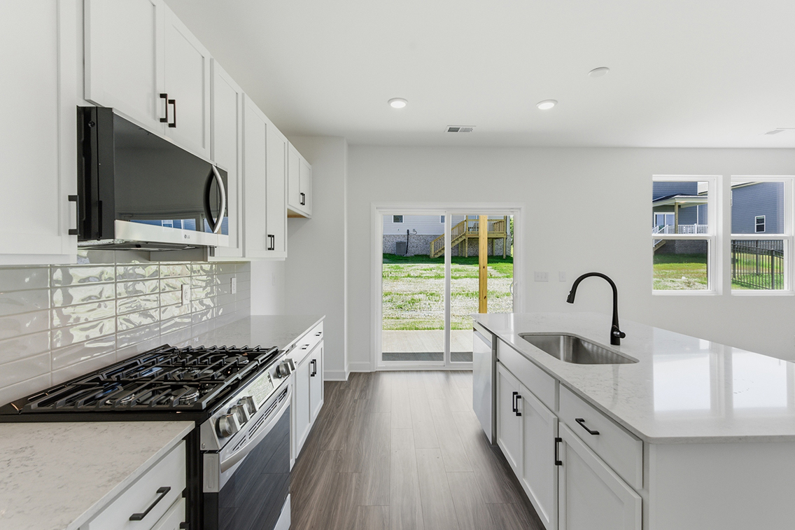 A kitchen with white cabinets.