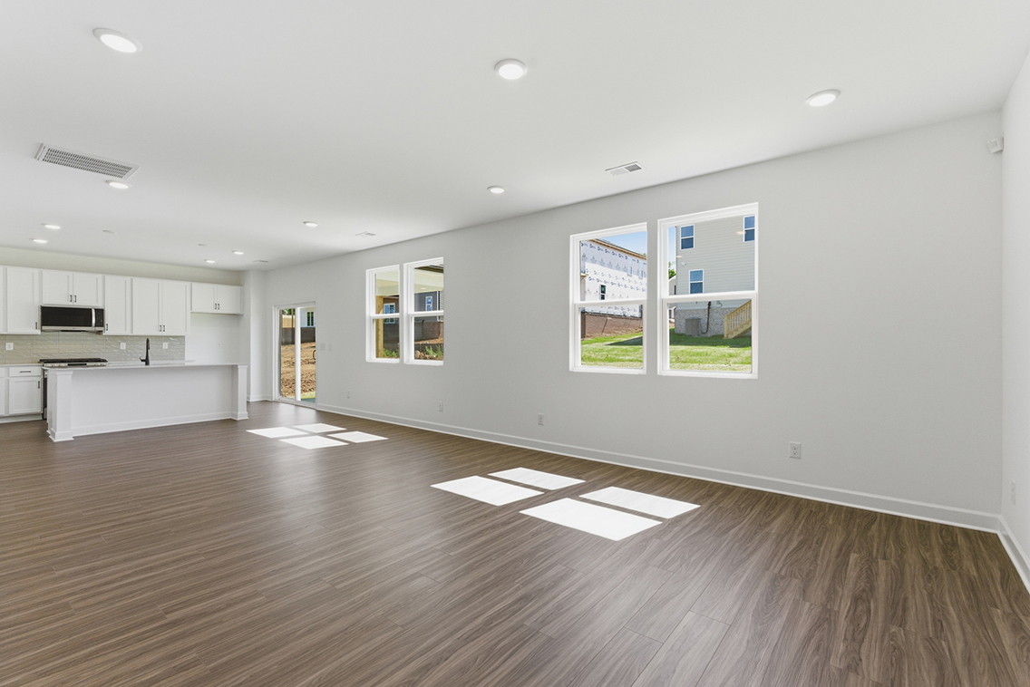 A room with a wood floor and white walls.