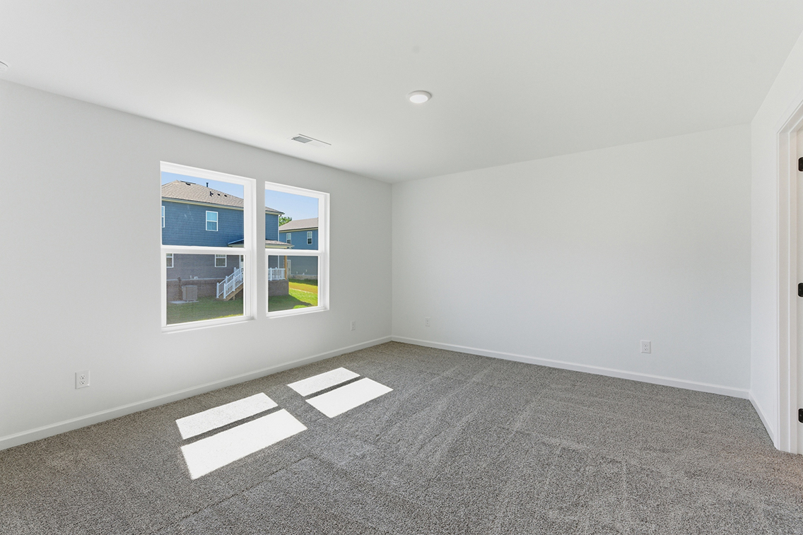 A room with white walls and a window.