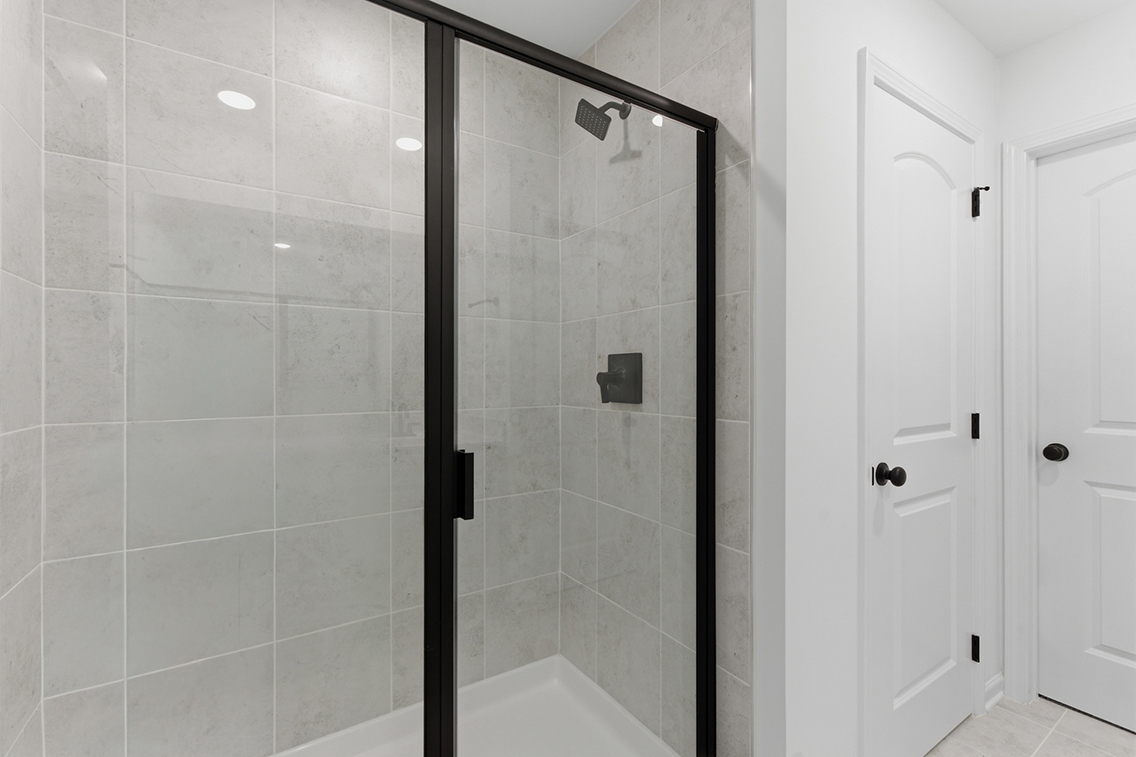 A shower with glass doors.