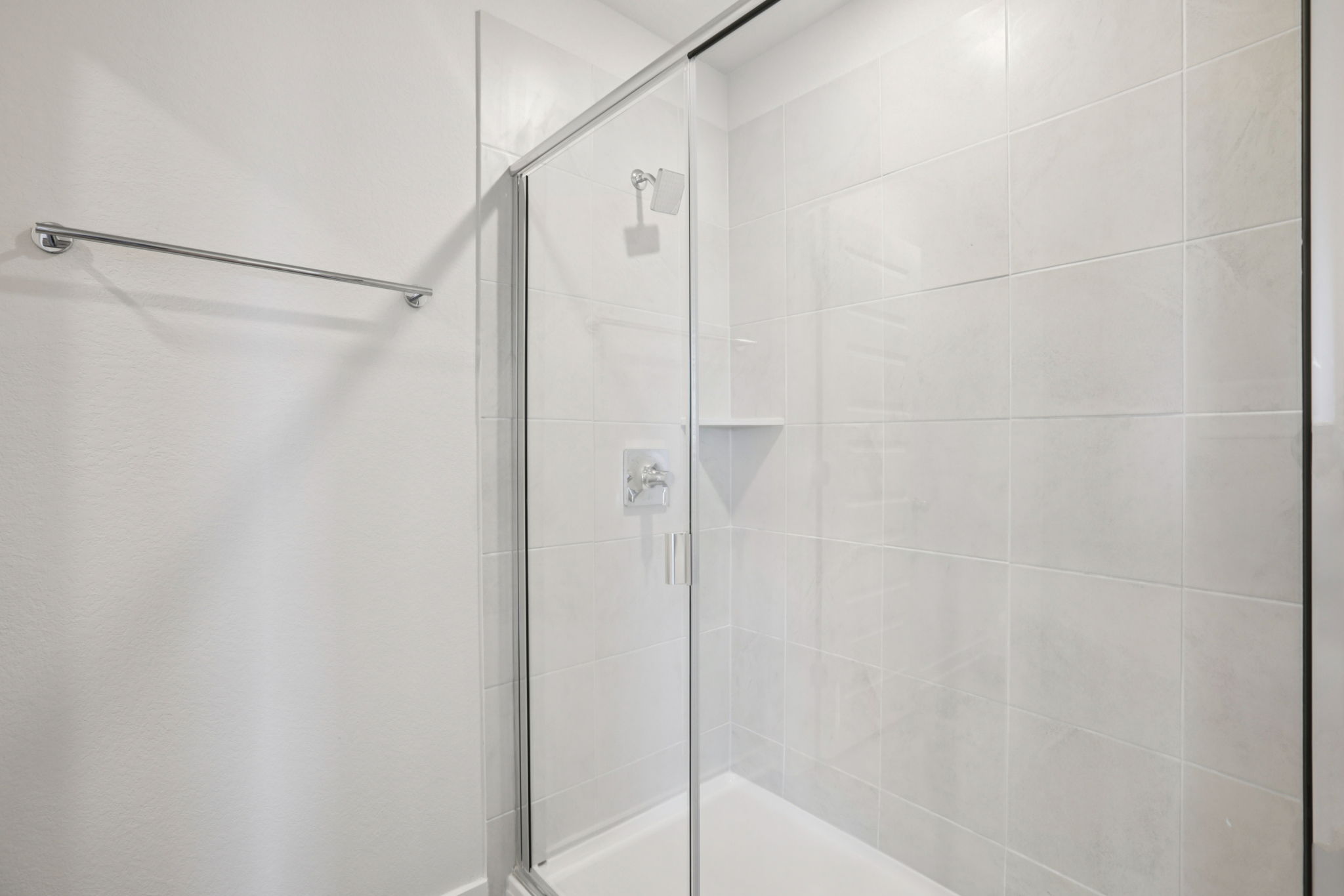 A shower with a glass door.