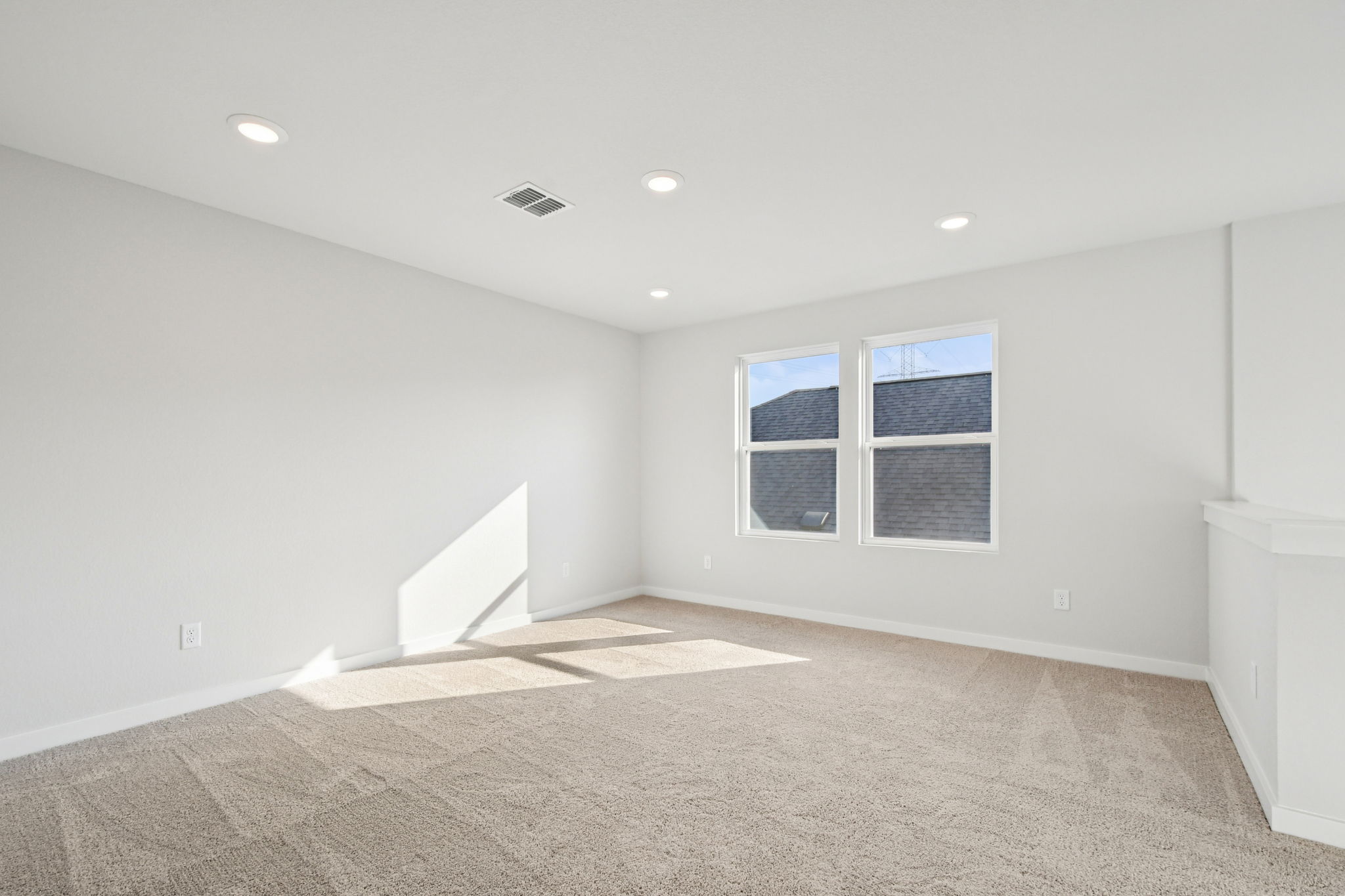 A room with a window and a rug.