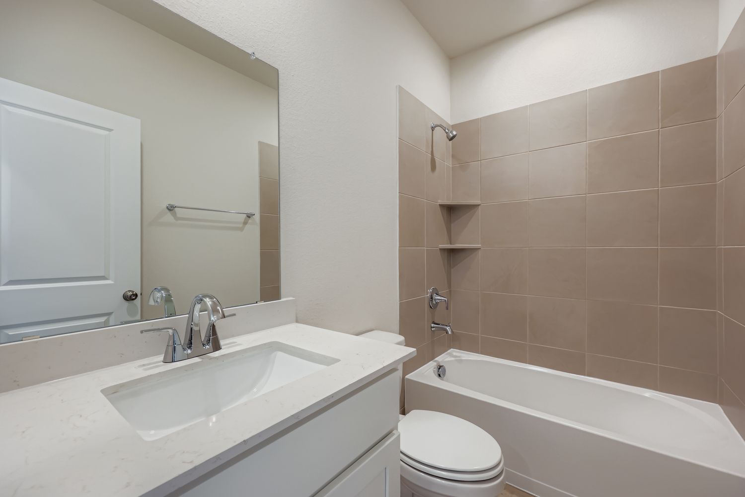 A bathroom with a sink toilet and bathtub.