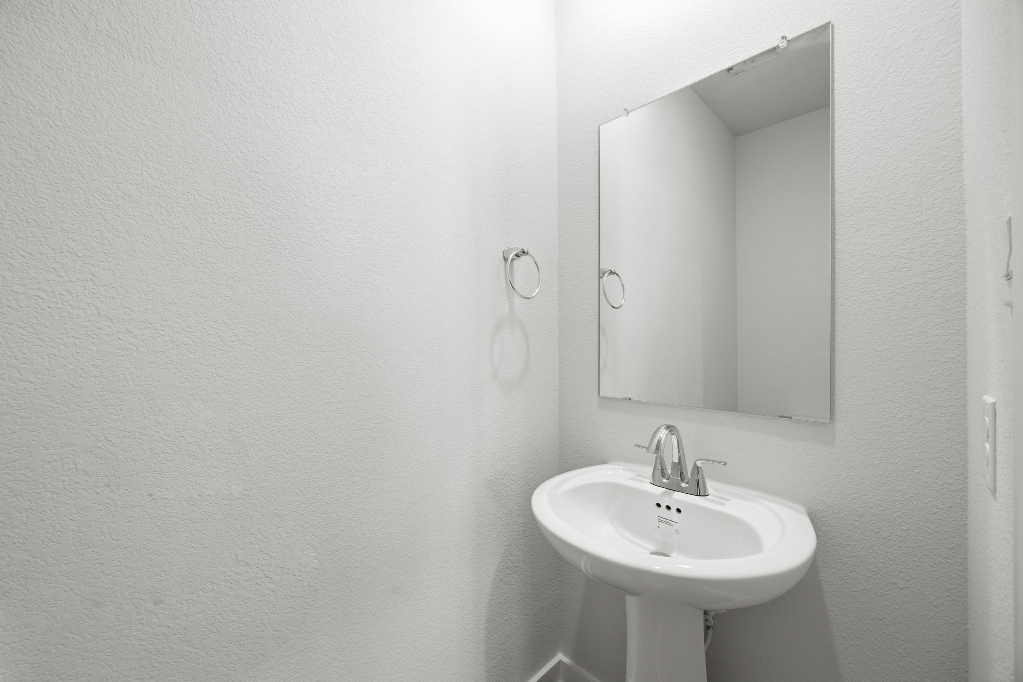 A bathroom with a mirror and sink.