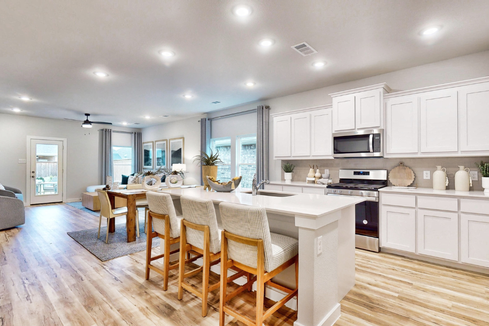 A kitchen with white cabinets.