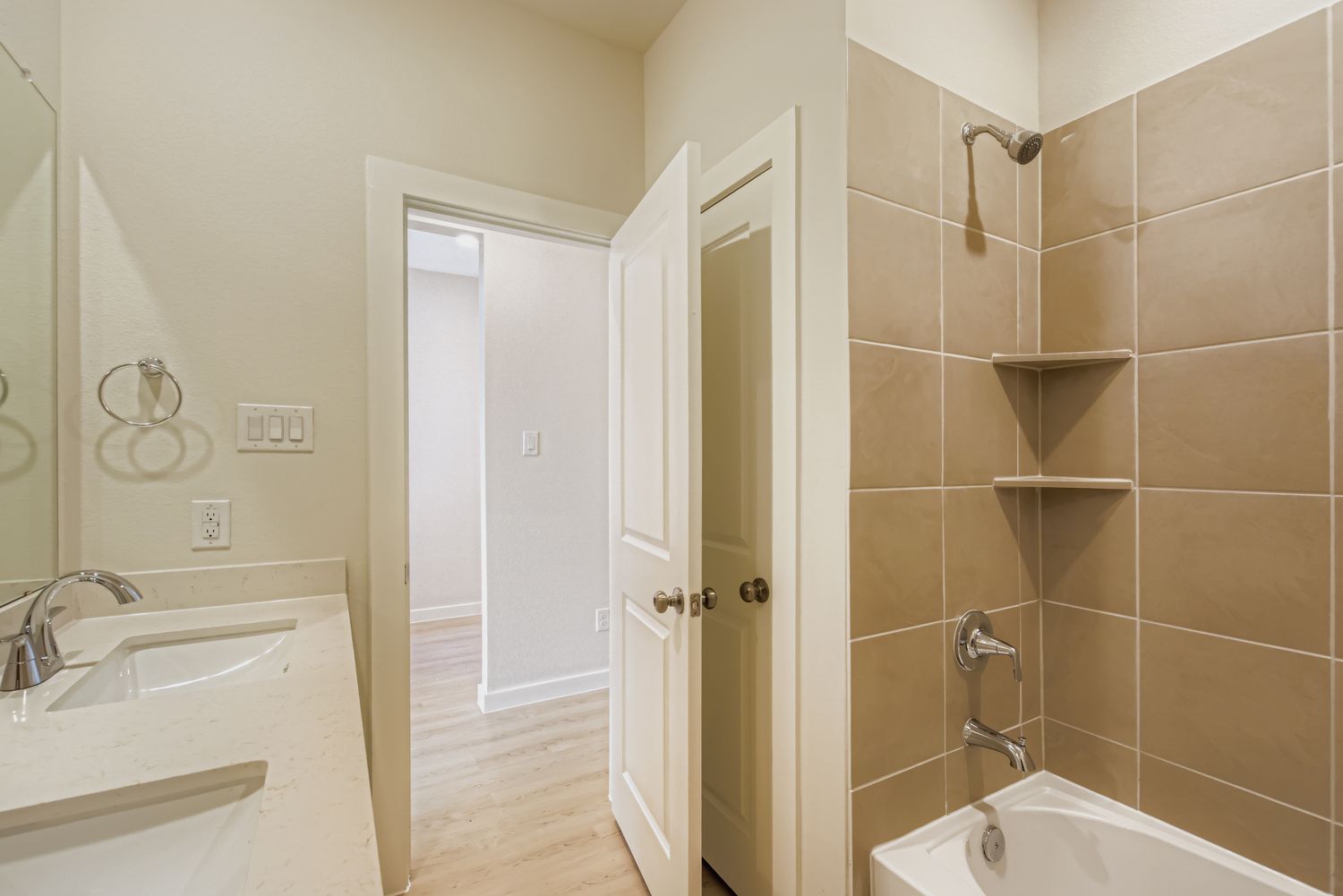 A bathroom with a tub sink and shower.