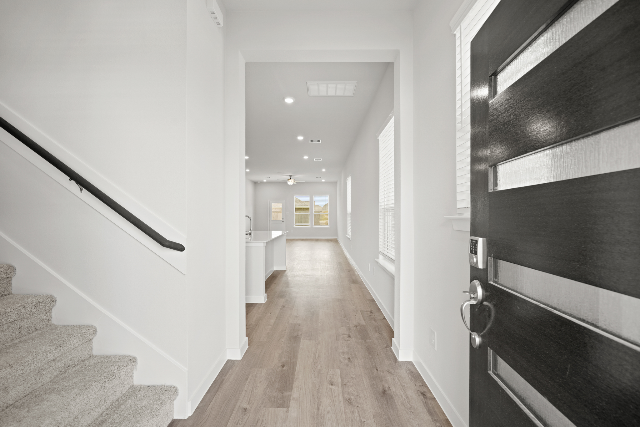 A hallway with a wood floor.