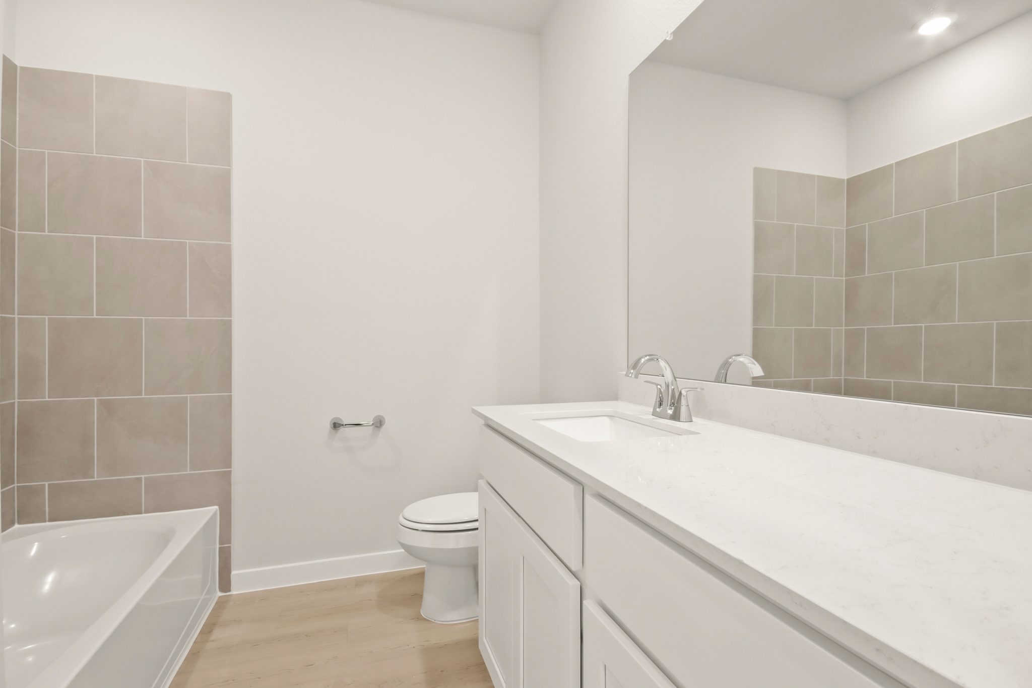 A bathroom with a tub sink and toilet.