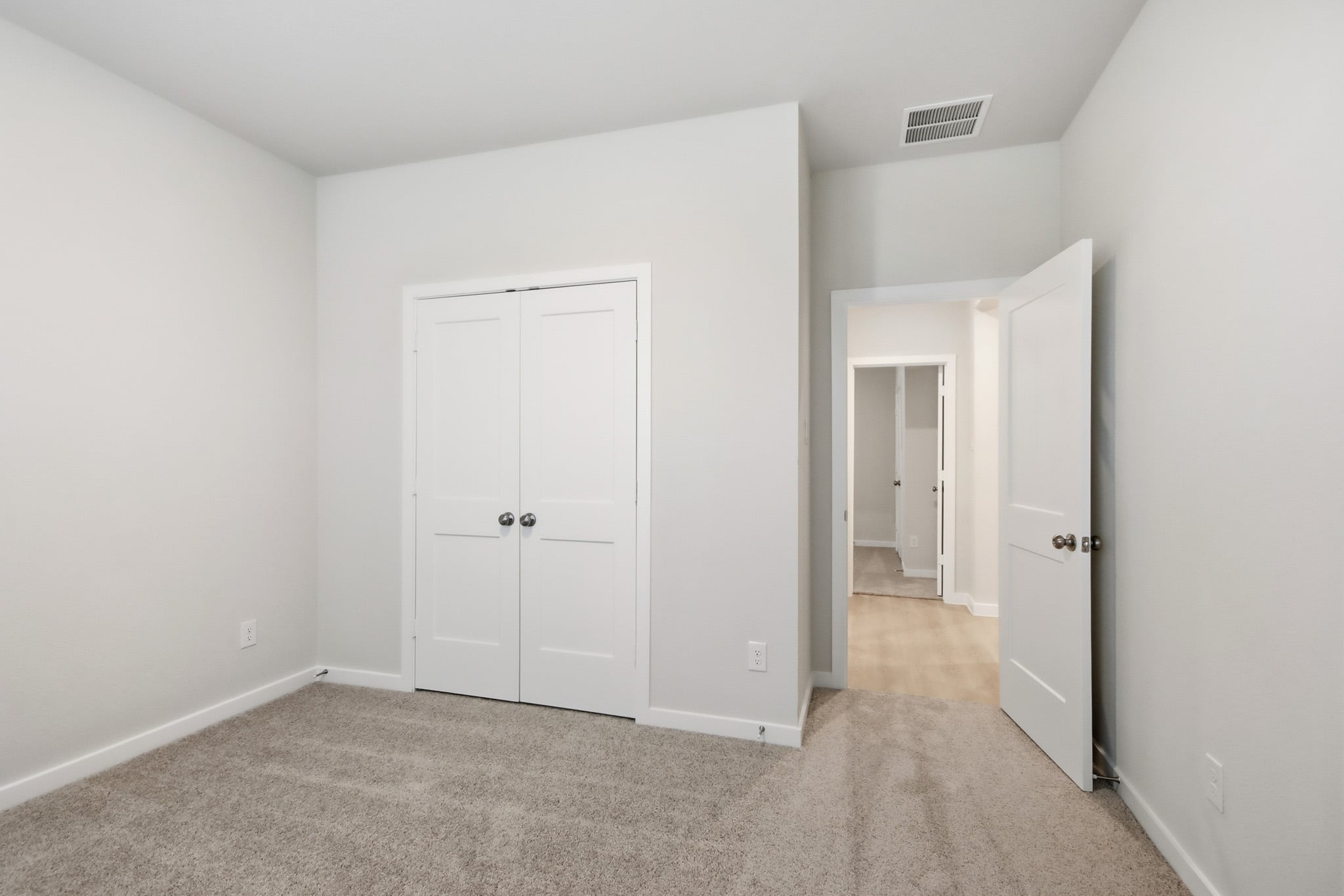 A hallway with white doors.