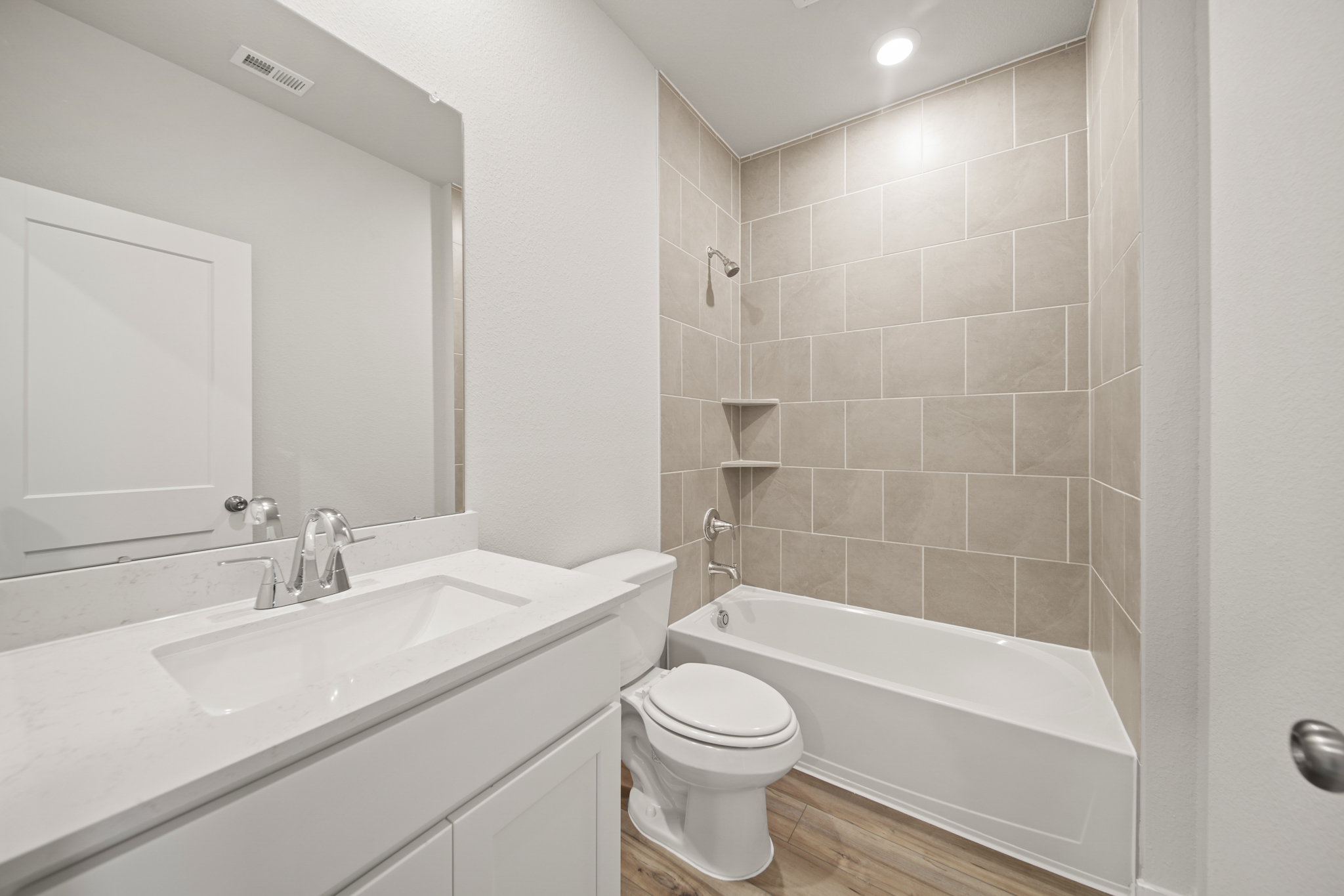 A bathroom with a tub sink and toilet.
