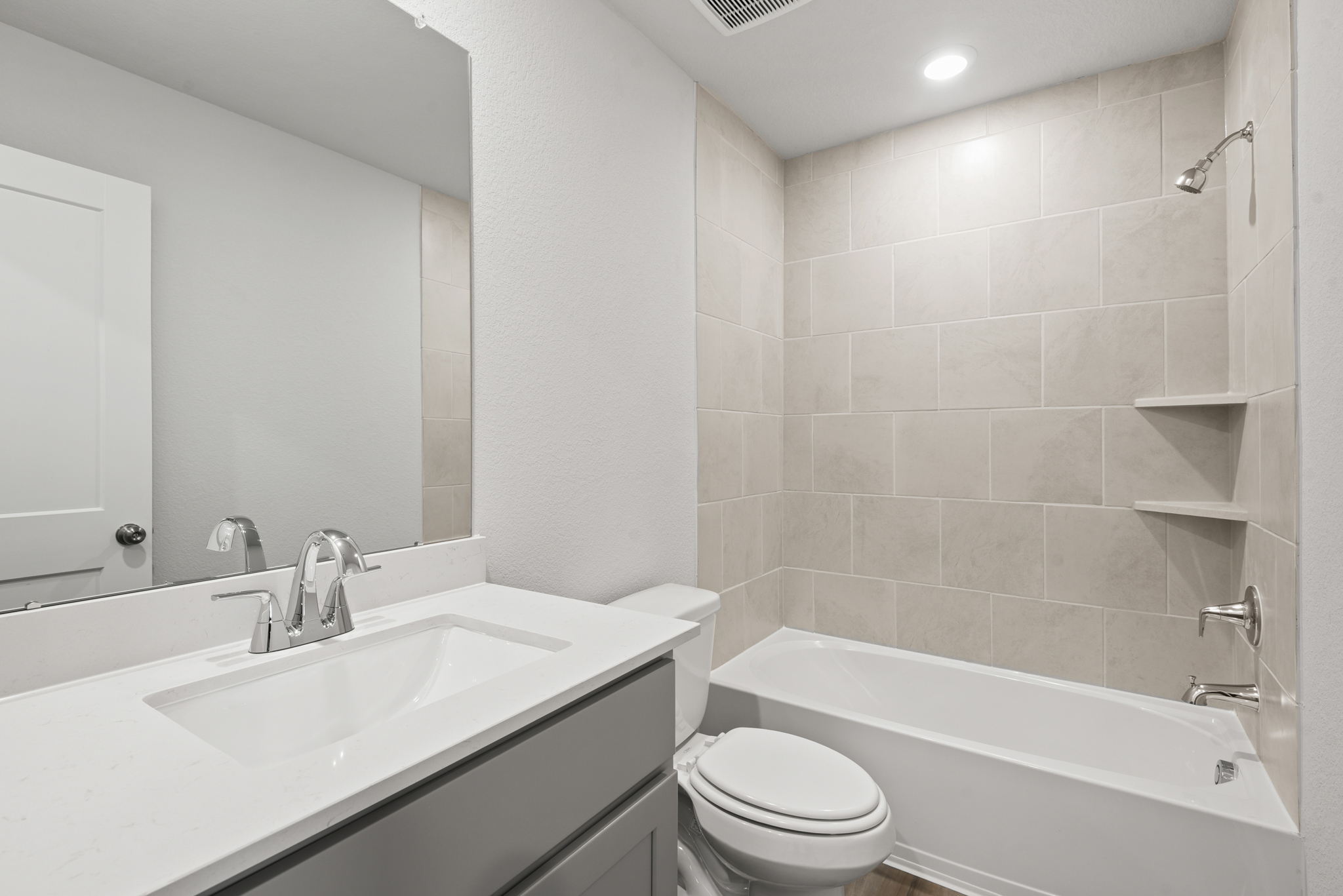 A bathroom with a tub sink and toilet.