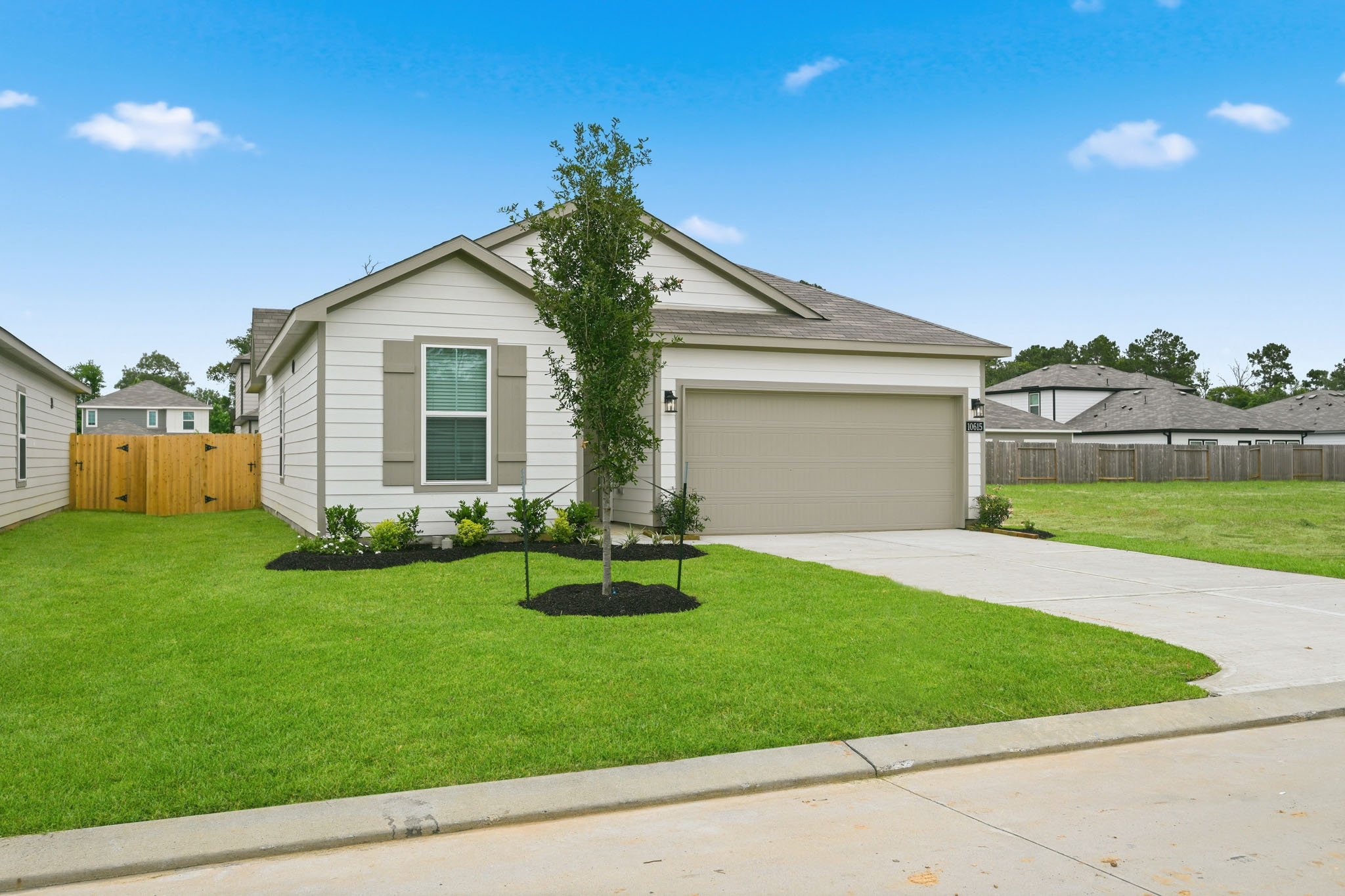 A house with a tree in the front yard.